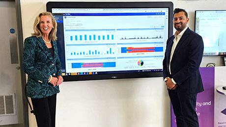 Sarwar Khan (global head of digital sustainability, Business, BT) and Katie McGinty (vice president and chief sustainability and external relations offer, Johnson Controls) review energy usage data of the digital twin at Adastral Park that incorporates OpenBlue technology.
