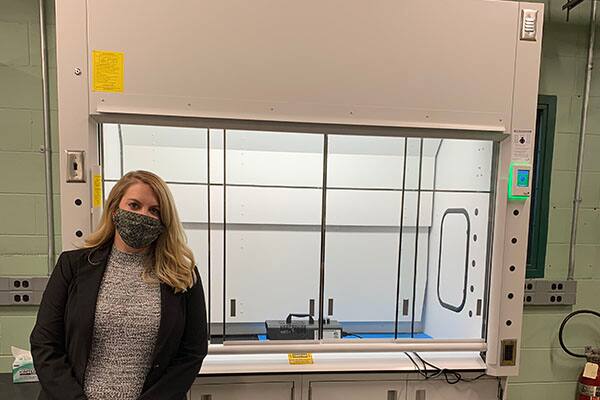 Johnson Controls' Beth Mankameyer poses in front of one of the new fume hoods at Purdue University's Ray W. Herrick Laboratories.