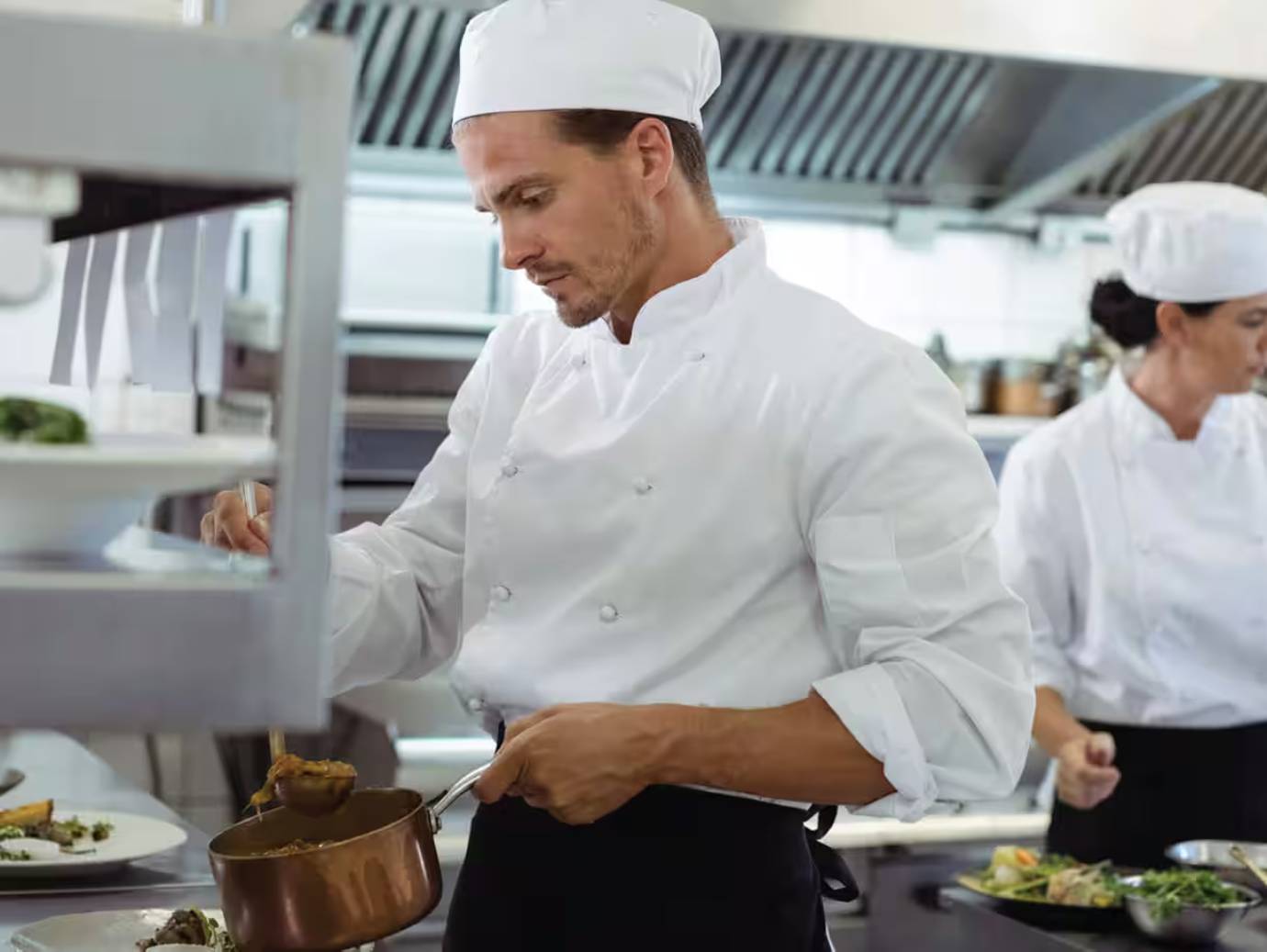A chef preparing a meal in a restaurant kitchen