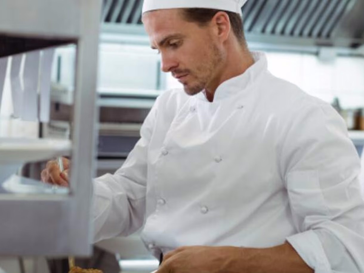 Chefs preparing meals in a restaurant kitchen