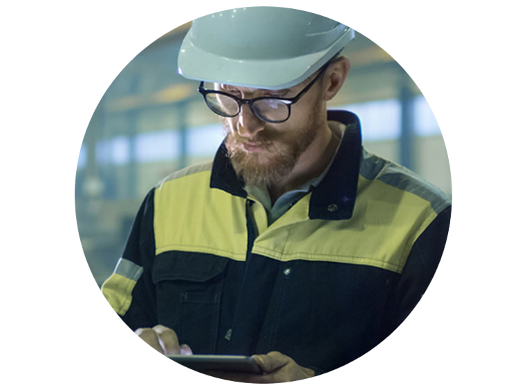 Engineer in a safety helmet looking at a tablet