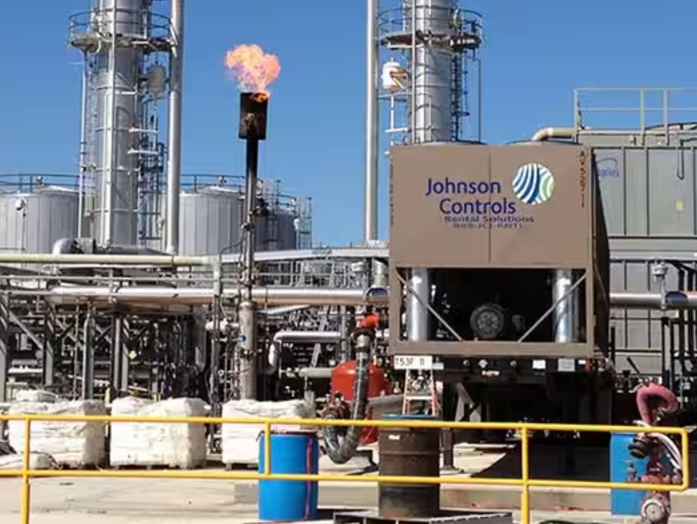 A yard in an industrial facility, with a carton bearing the Johnson Controls logo