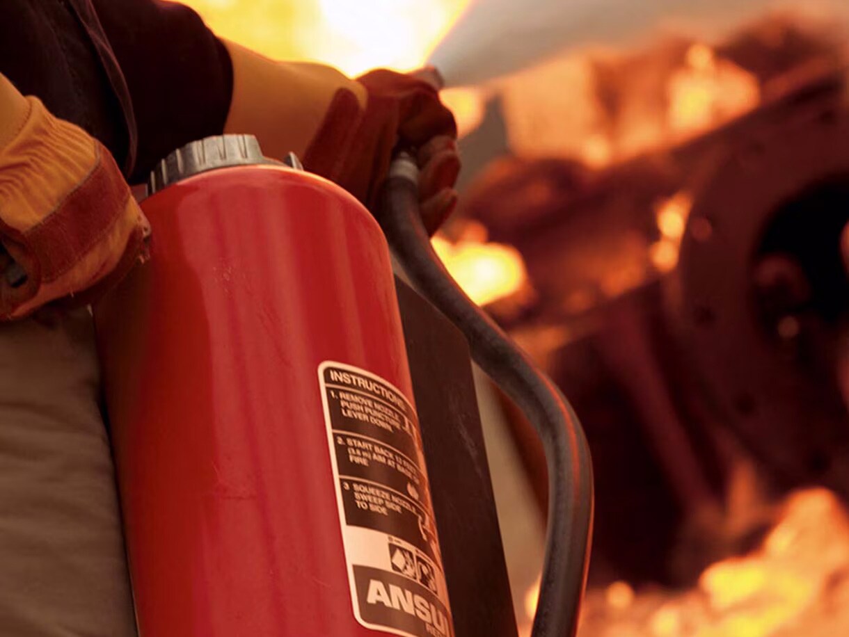 A fire extignuisher being used to put out fire