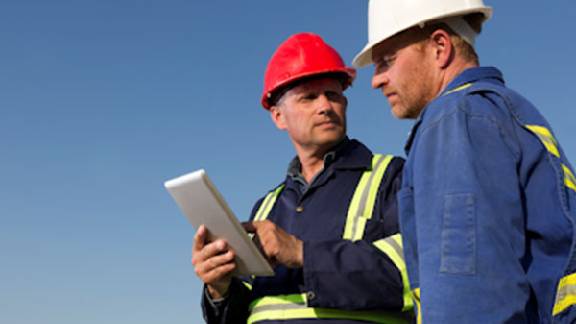 Workers discuss construction plans