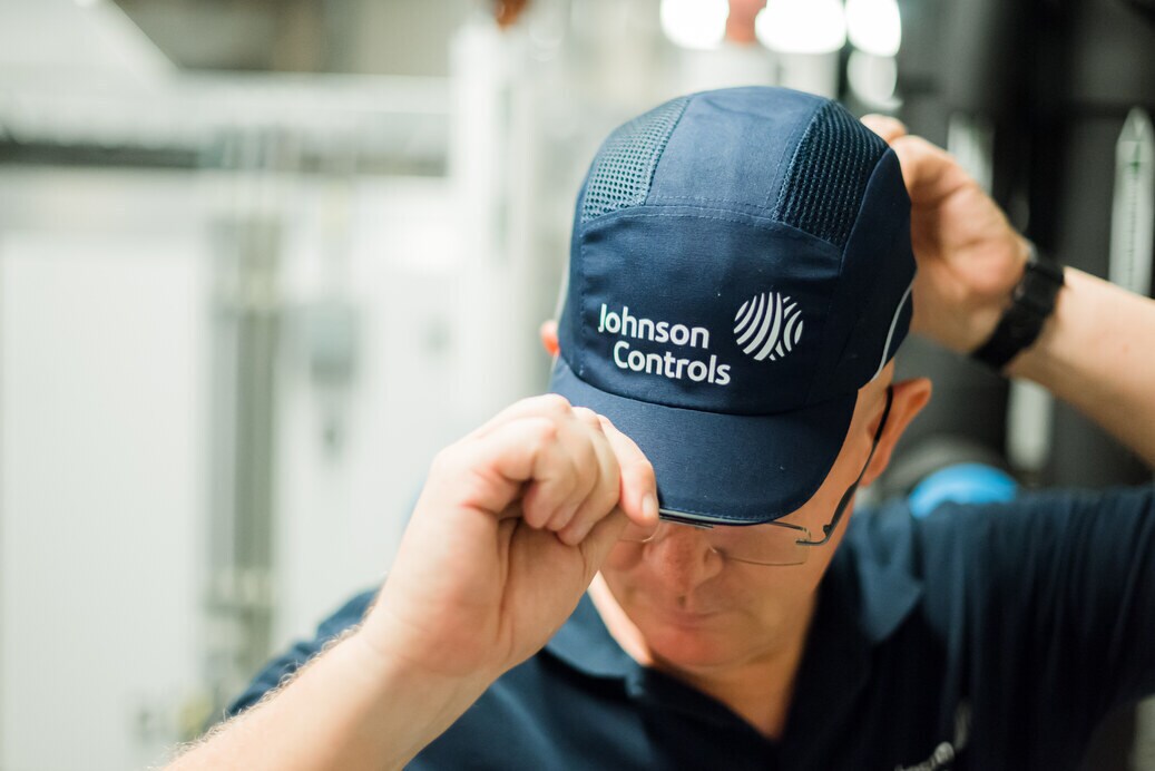 JCI employee wearing cap