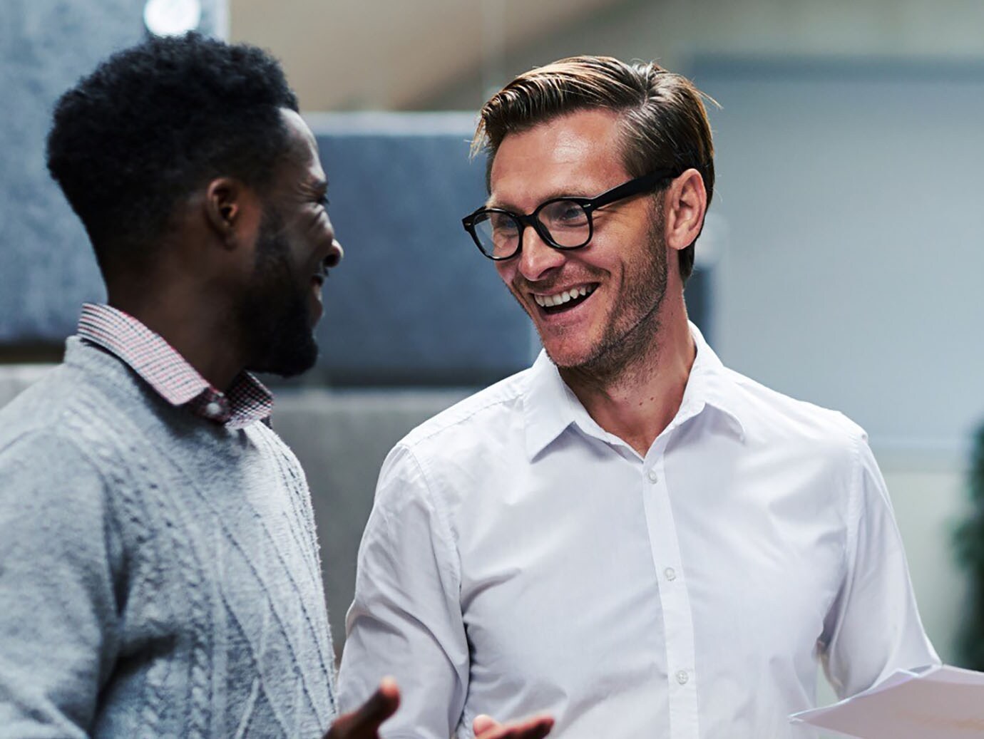 Two male colleagues having a hearty conversation