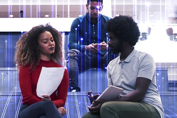 Group of university students sitting on the stairs and working