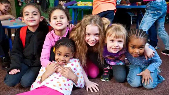 Group of school children smiling for a picture