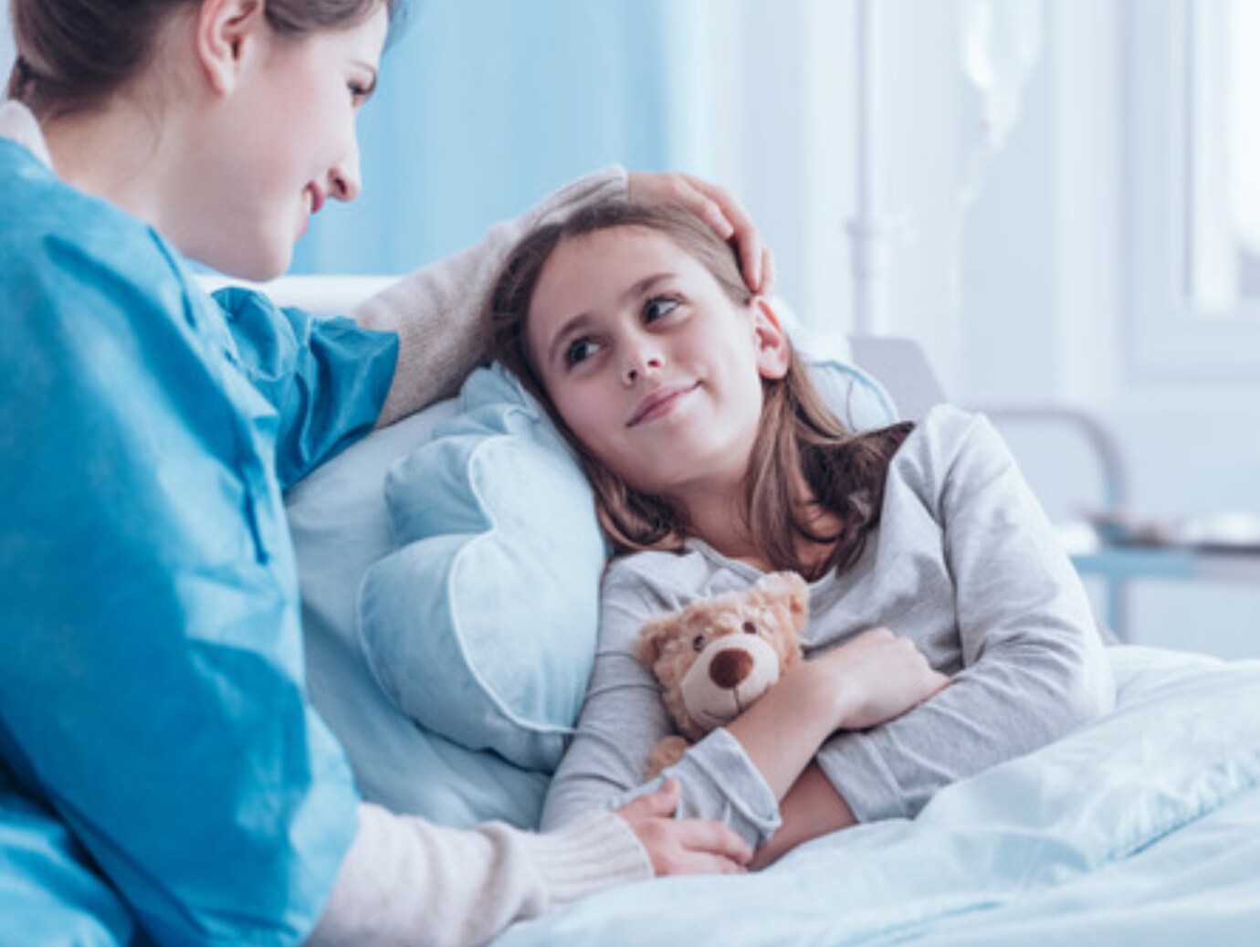 Nurse taking care of girl in hospital
