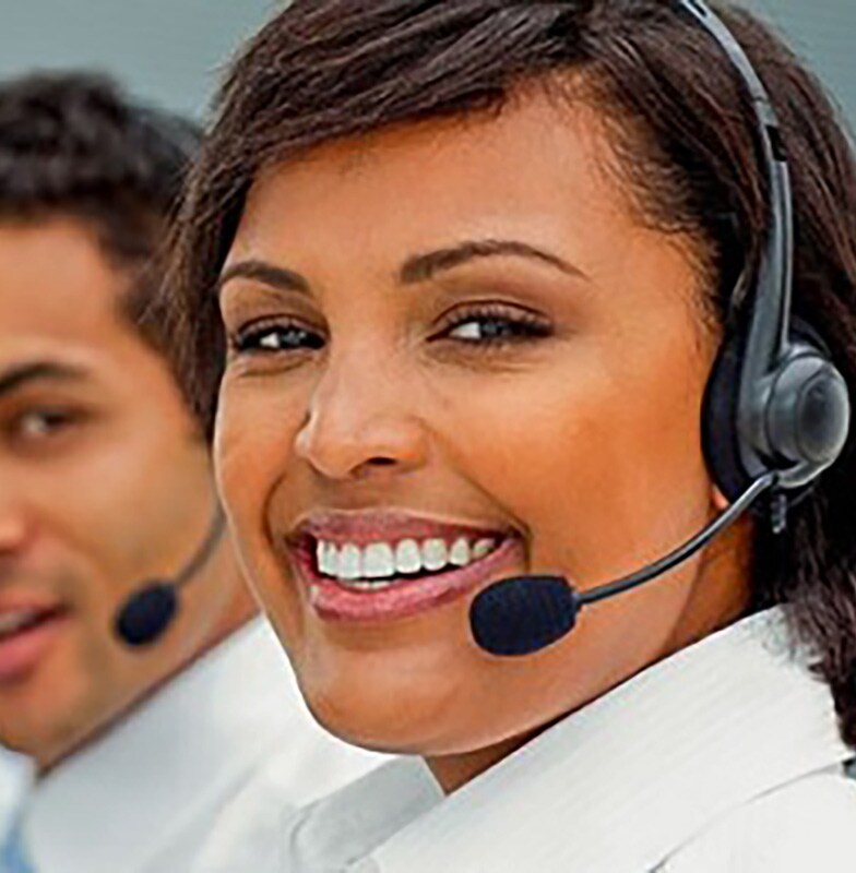 A row of call center employees smiling