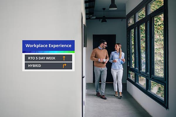 An image of two colleagues walking through a corridor