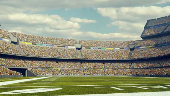 Football stadium full of spectators under blue sky