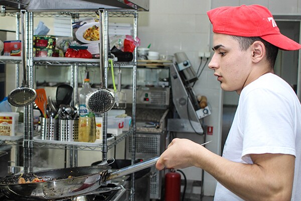 Man at work in the kitchen of a food joint