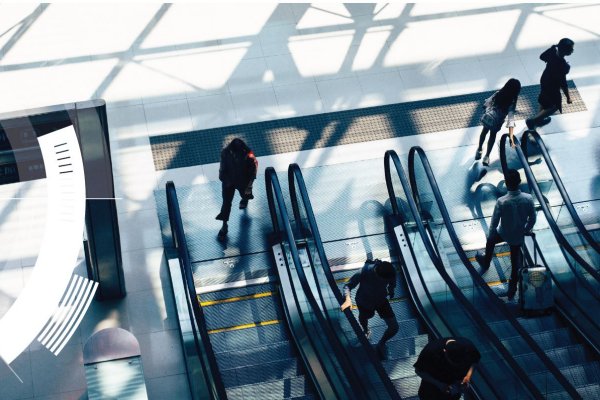 High-angle view of people using escalators in a commercial building