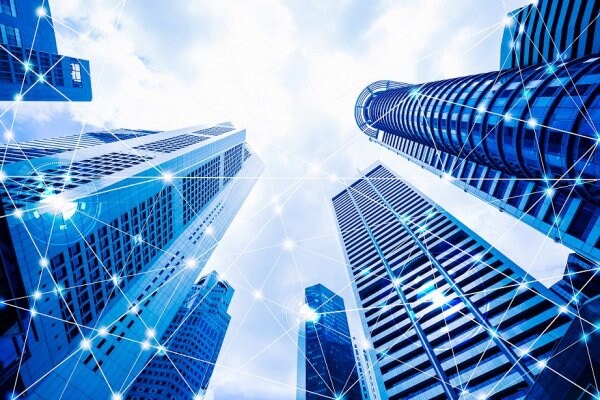 Frog's-eye view of corporate buildings, with graphics depicting cybersecurity overlaid on them