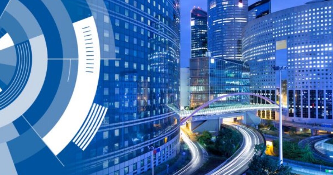 A view of corporate buildings in a city at dusk, with graphics depicting Digital Twinning overlaid on the left