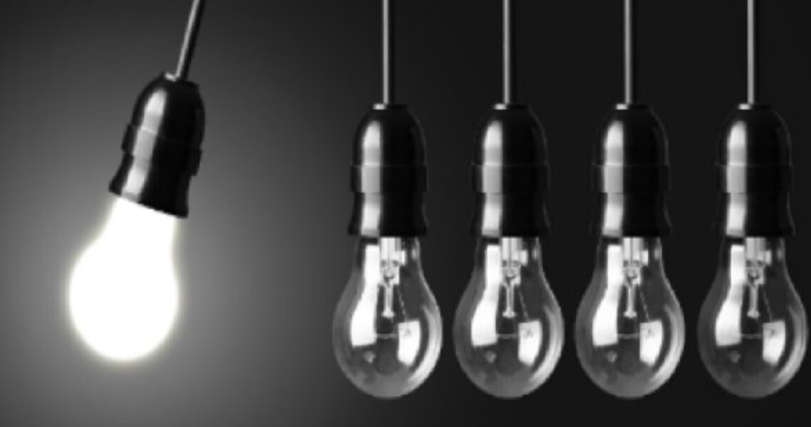 Five lightbulbs hanging in a row, with one lit up and swinging