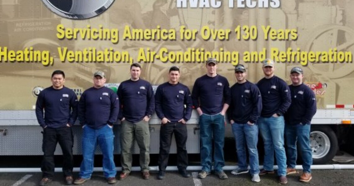 Plumbers and apprentices posing at a meet for plumbers, welders, fitter and HVAC technicians