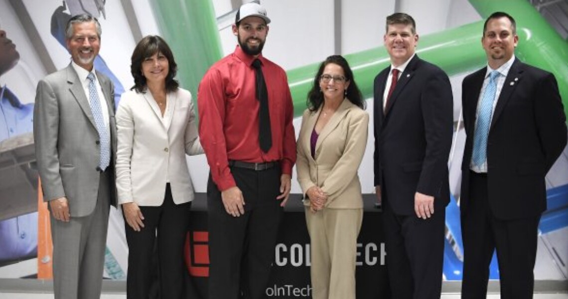 Executives and staff from Johnson Controls and Lincoln Tech at a ribbon cutting event to celebrate the partnership between Johnson Controls and Lincoln Tech