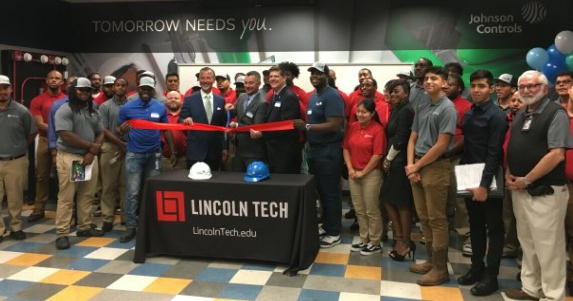 People gathered at a ribbon cutting ceremony celebrating the launch of vocational classrooms by Johnson Controls and Lincoln Tech