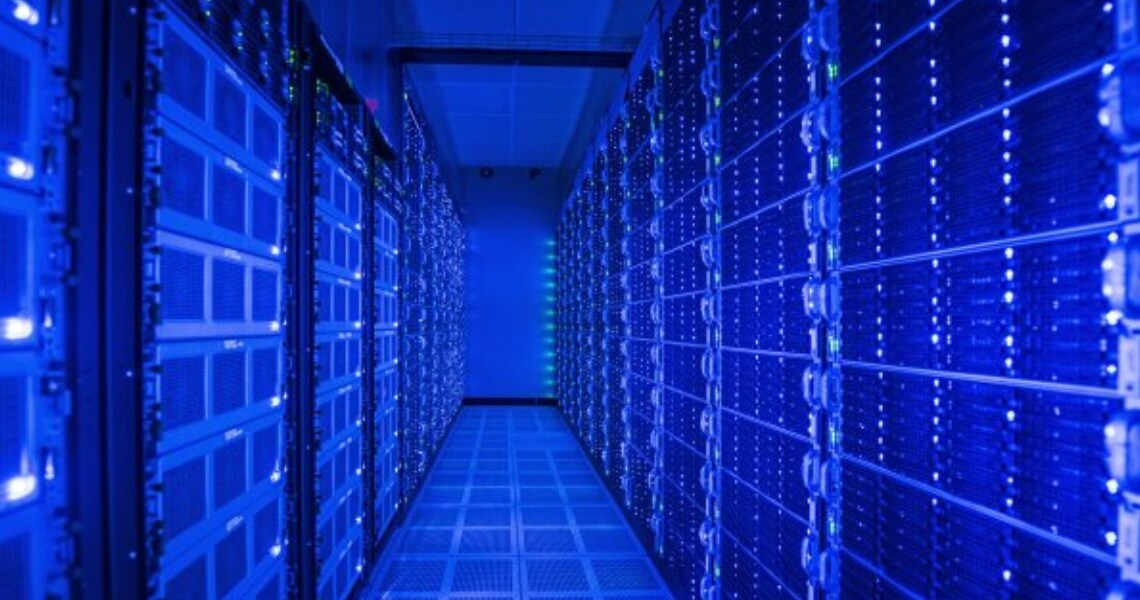 A narrow passage in a server room lined with panels