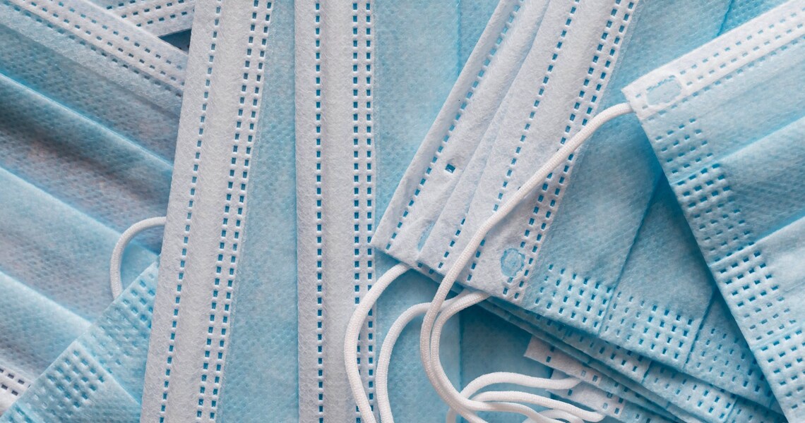 Close-up of a pile of blue fabric face masks 