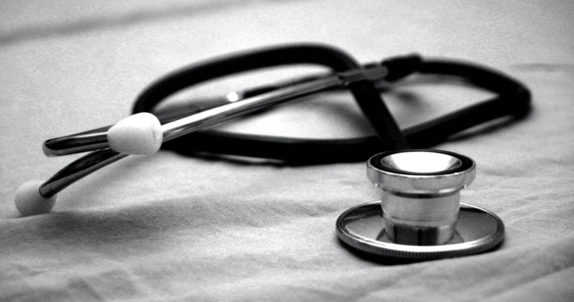 Close-up of a stethoscope lying on a white sheet 