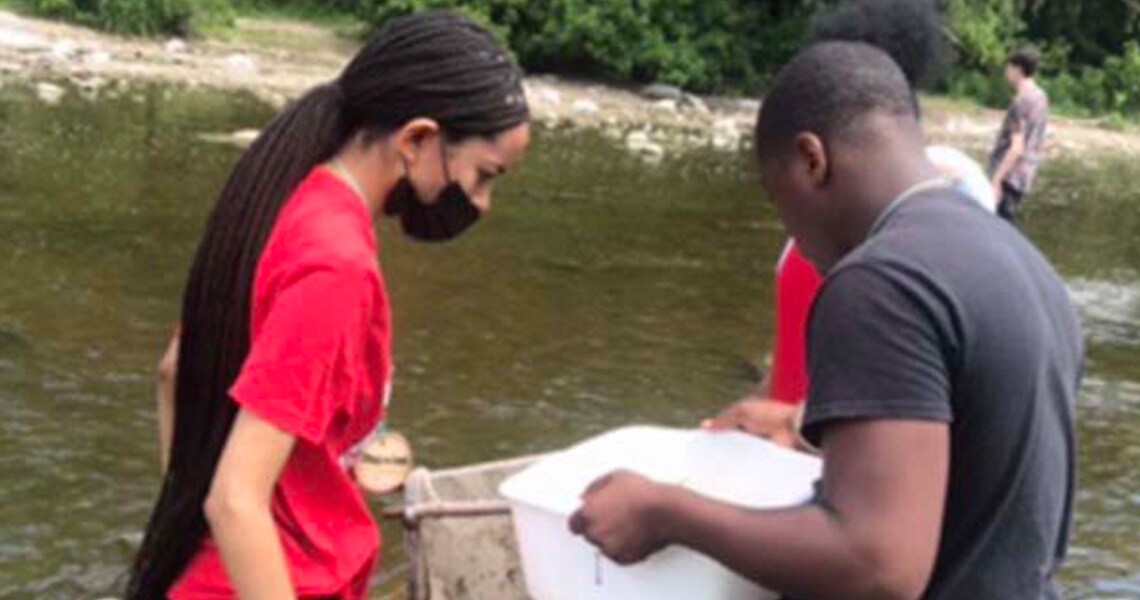 A man and women searching something in the river