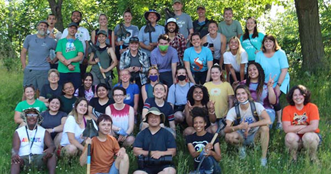 A group of people posing in jungle