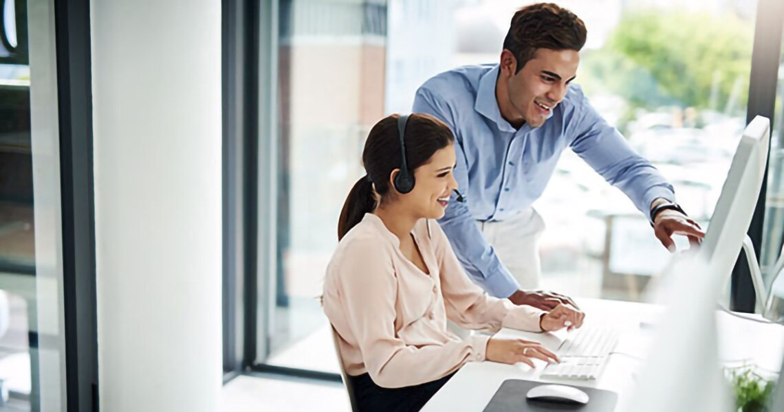 A man having a conversation with his female colleague at their workplace