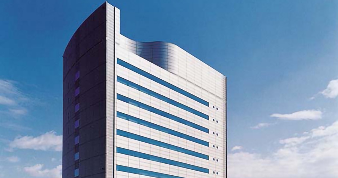 Modern high-rise tower against the blue sky