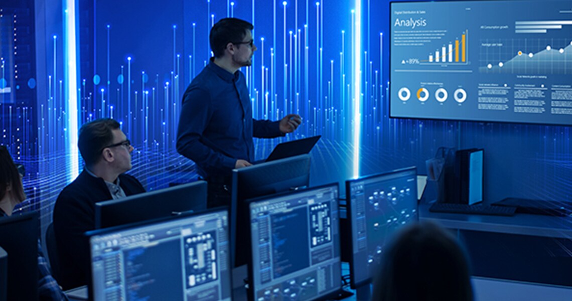 Man presenting analytical infographics to a group of people in a meeting room, with a graphic of transmission nodes overlaid on the background
