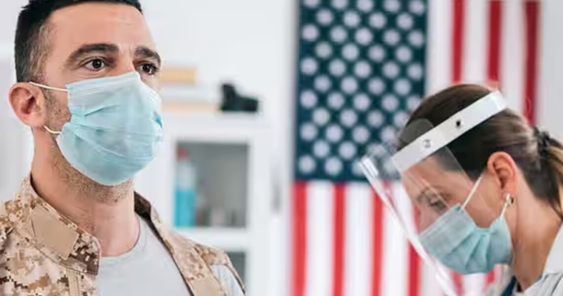 A man and a healthcare professional in a face mask