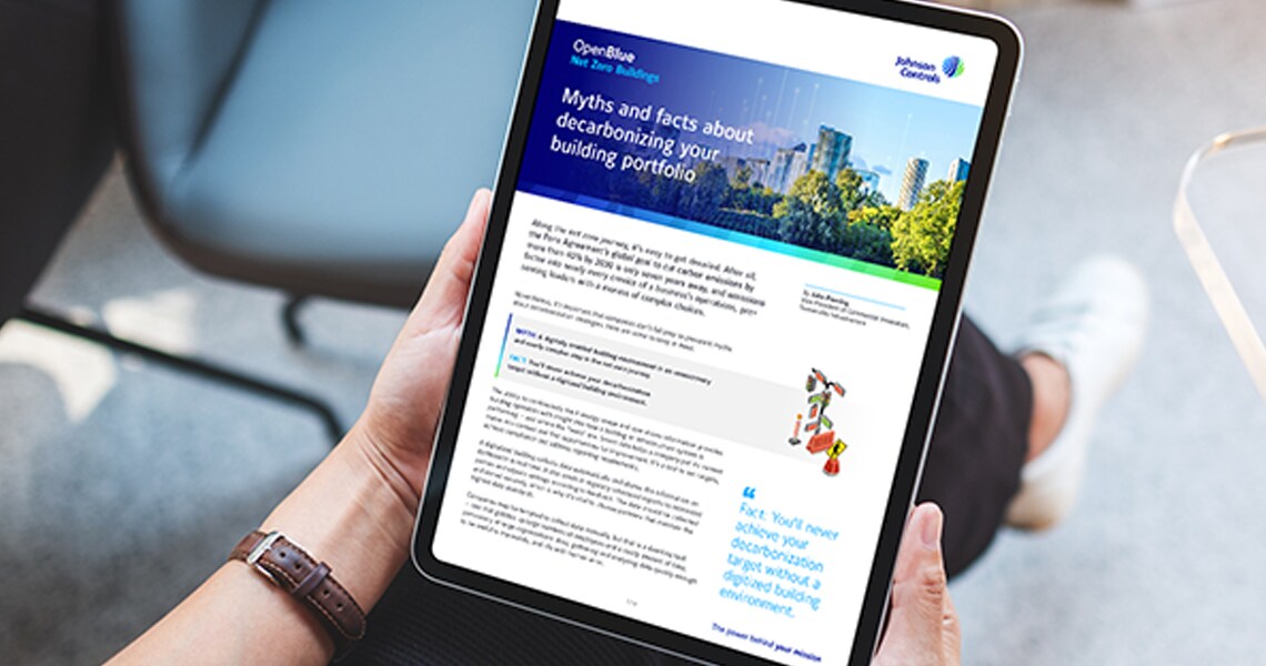 Close-up of a person holding a tablet displaying an OpenBlue white paper