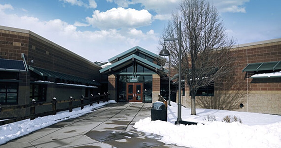 Entrance of an elementary school building, surrounded by melting snow