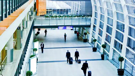 Top-angle view of an airport lobby busy with people