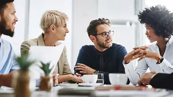 A group of colleagues in discussion around a table