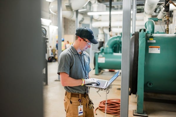 A technician looking into laptop