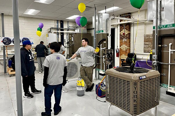 Waukegan High School students show off some of the equipment in the HVAC lab