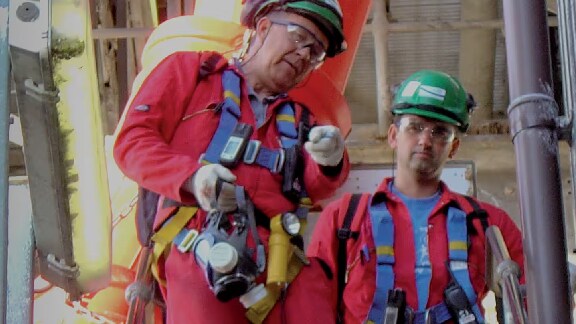 Rescue team in safety gear discussing and working