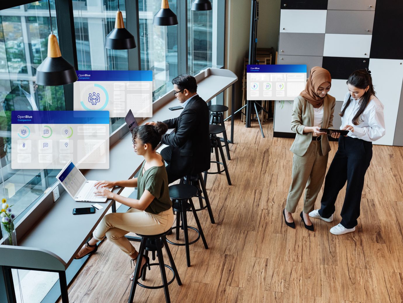people sitting on desk and other standing behind doing work