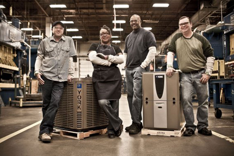 Four peoplee standing with York products in a factory in Wichita, KS
