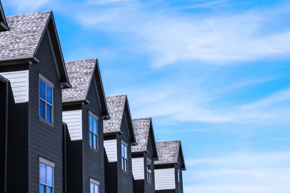 A row of houses against a clear sky