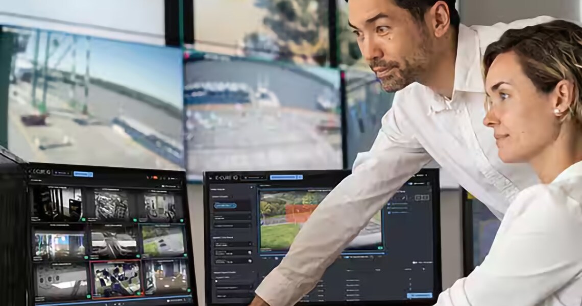 Two employees working on computers with "Software House" written at the bottom right side