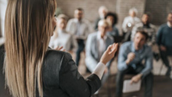 woman giving presentation in board room