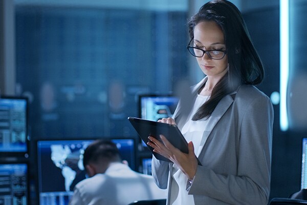 Woman working on a tab in a control room