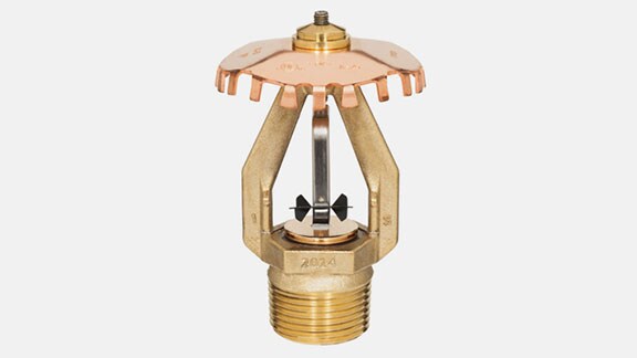 a golden sprinkler on  grey background