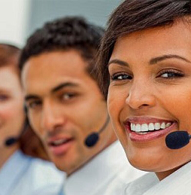 four people wearing headphones looking at camera