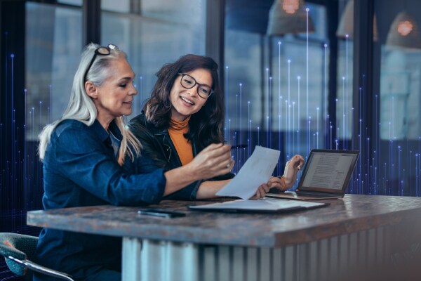 Two women discussing a document at work