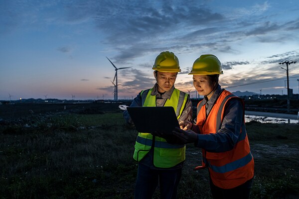 A man and woman checking on tablet